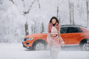 a mother and daughter walking away from their car amid heavy snow in Pennsylvania